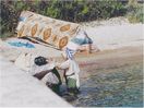 lady doing her washing in the harbor of Kala Nera